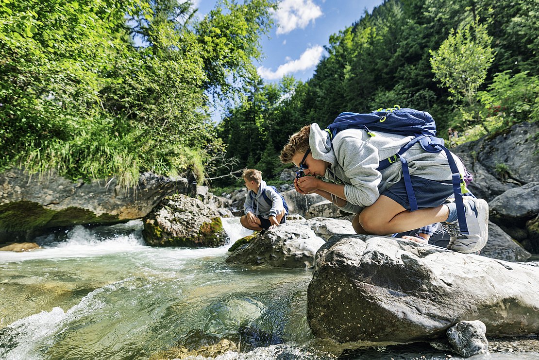 Teenage kids hiking in the Austrian mountains - Alps, Tyrol, Austria.